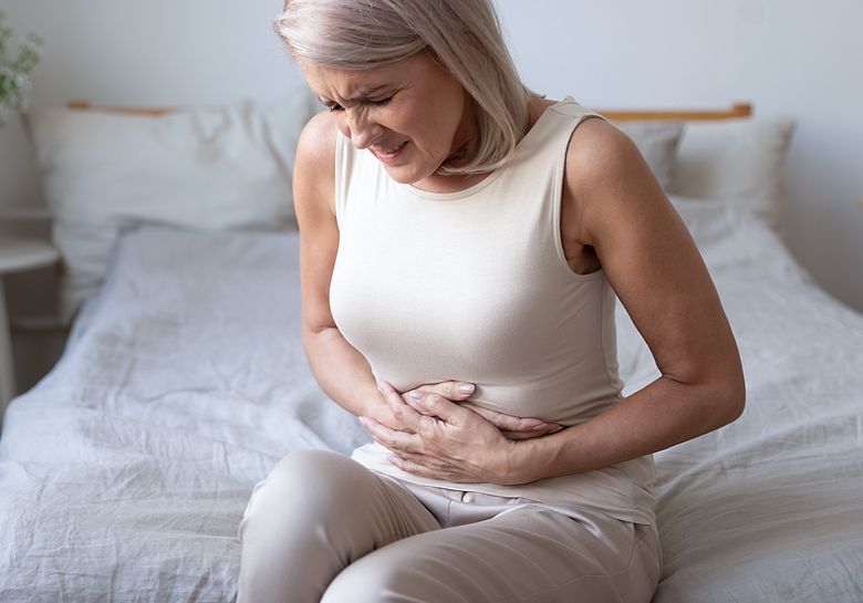 woman-with-stomach-pain-on-bed